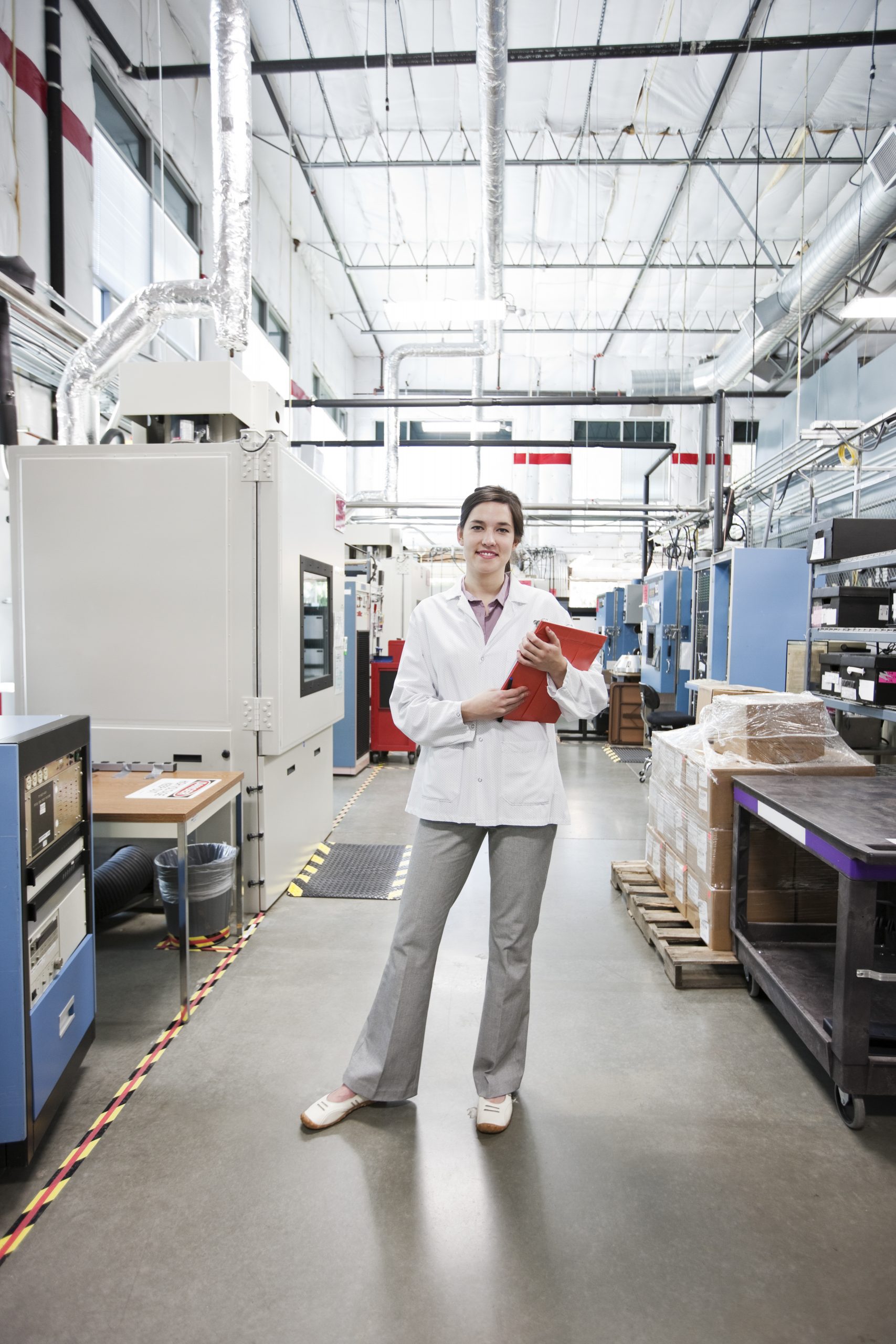 A portrait of a caucasian female technician in a technical research and development site. firevac